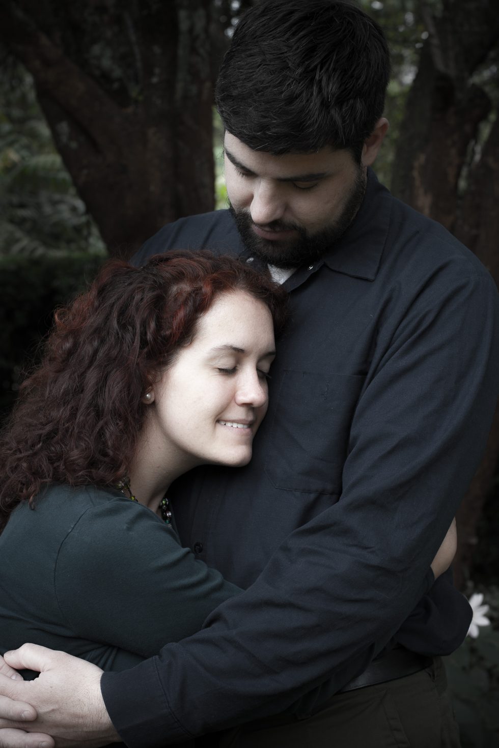 engagement photo of couple snuggled together